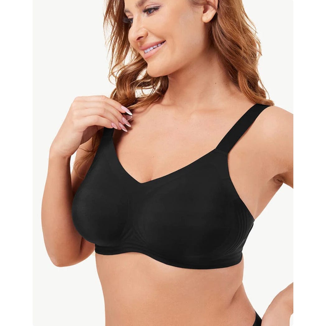 A woman is wearing a plain black bra with wide straps.