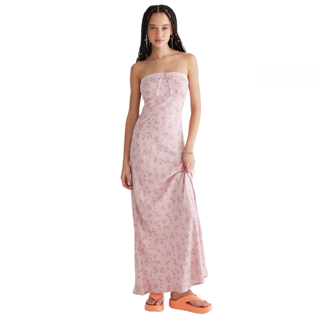 Pink strapless midi dress with a delicate floral print and lace trim at the top; paired with bright orange platform sandals.