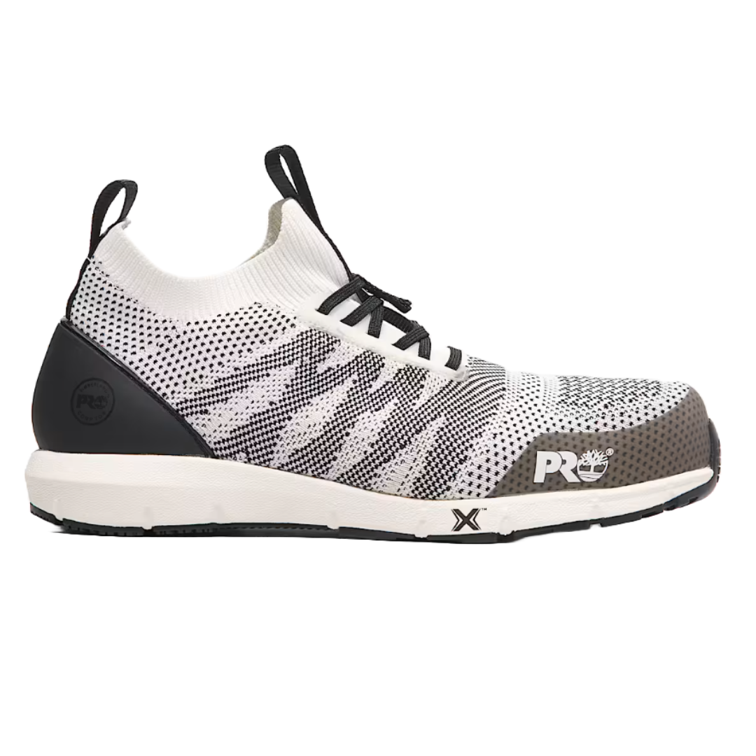Timberland Radius Knit Work Sneakers feature a black and white knit upper with a reinforced toe, black laces, and a cushioned white sole. The design includes PRO branding and a flexible, lightweight construction for work environments.