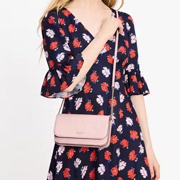A navy blue floral dress paired with a pink crossbody bag.