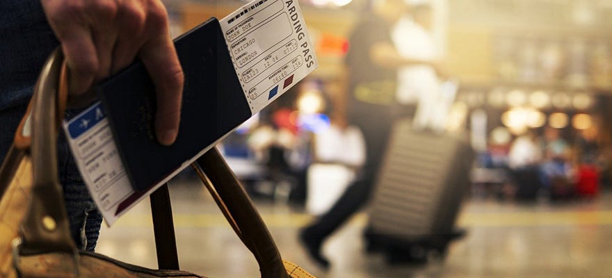 man with boarding pass at airport