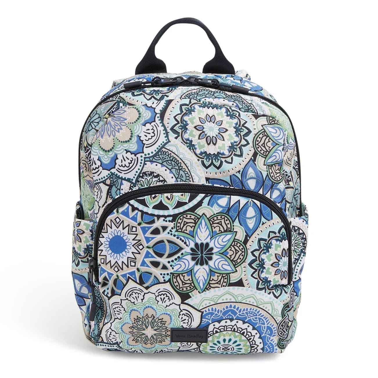 Compact backpack featuring a vibrant blue and green mandala pattern, a front zippered pocket, and dual side slip pockets.