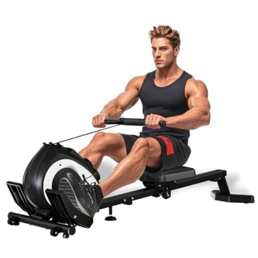 A man is using a rowing machine. He wears a black tank top and black-red shorts, sitting with feet strapped to the footrests and hands gripping the handlebar. The machine is designed for cardiovascular and strength training exercises.