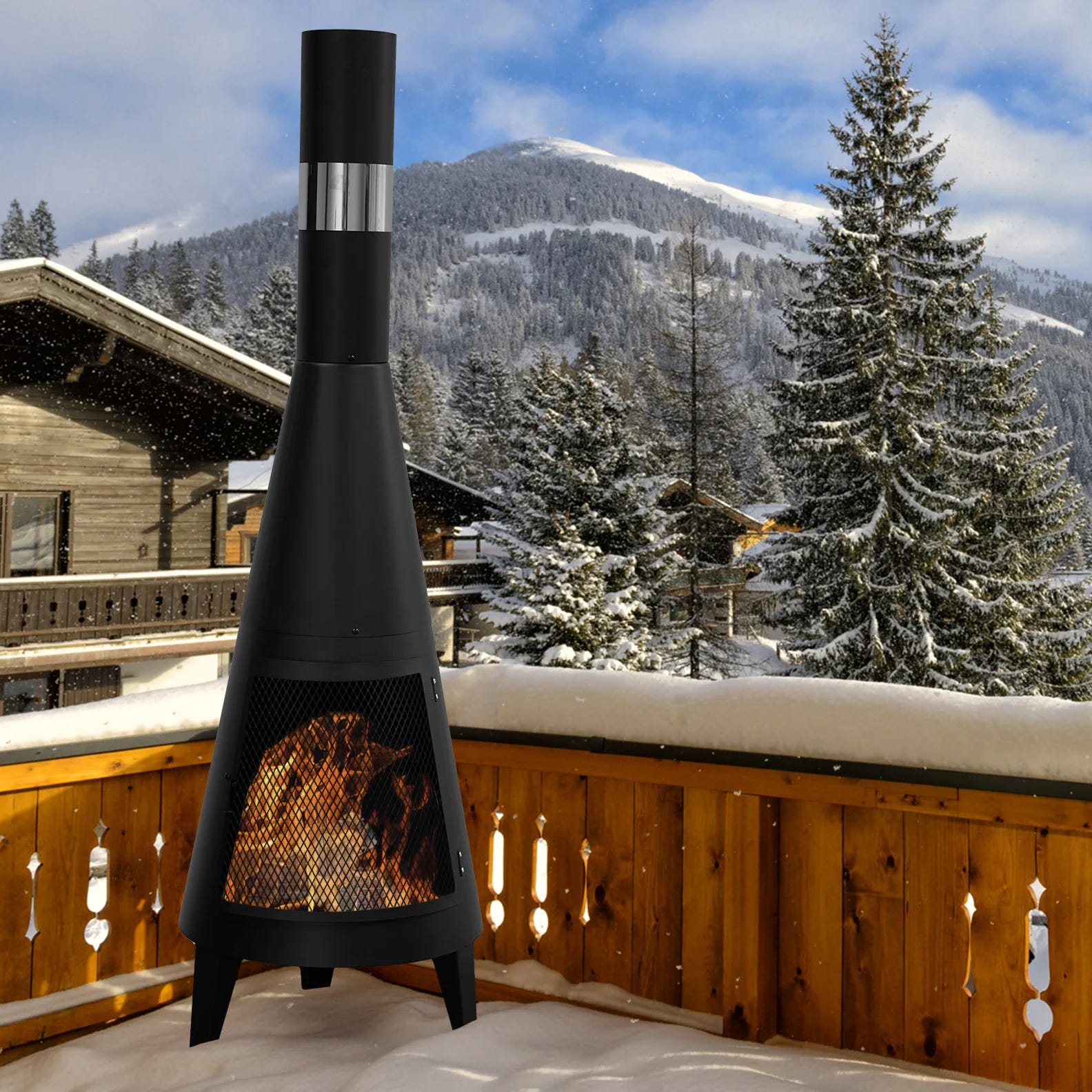 A modern outdoor fireplace with a visible fire chamber set against a snowy mountain landscape.