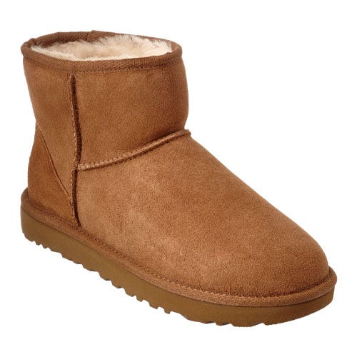 Chestnut-colored suede boots with a mid-ankle height, featuring a rounded toe and a soft, plush lining. They have a flat, textured sole for grip.