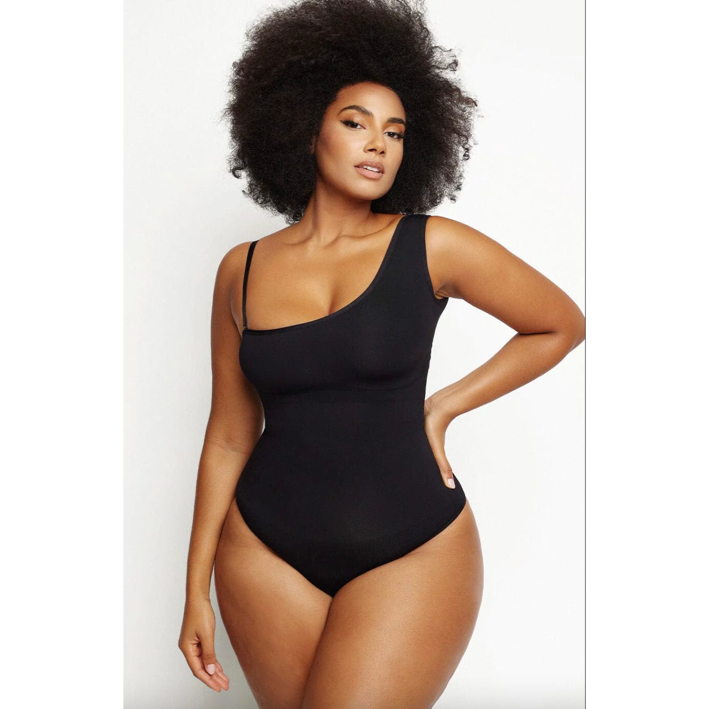 A person wearing a black sleeveless bodysuit.