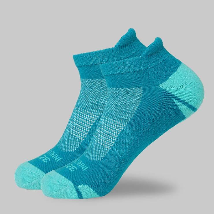A pair of turquoise ankle socks with different shades and textures.