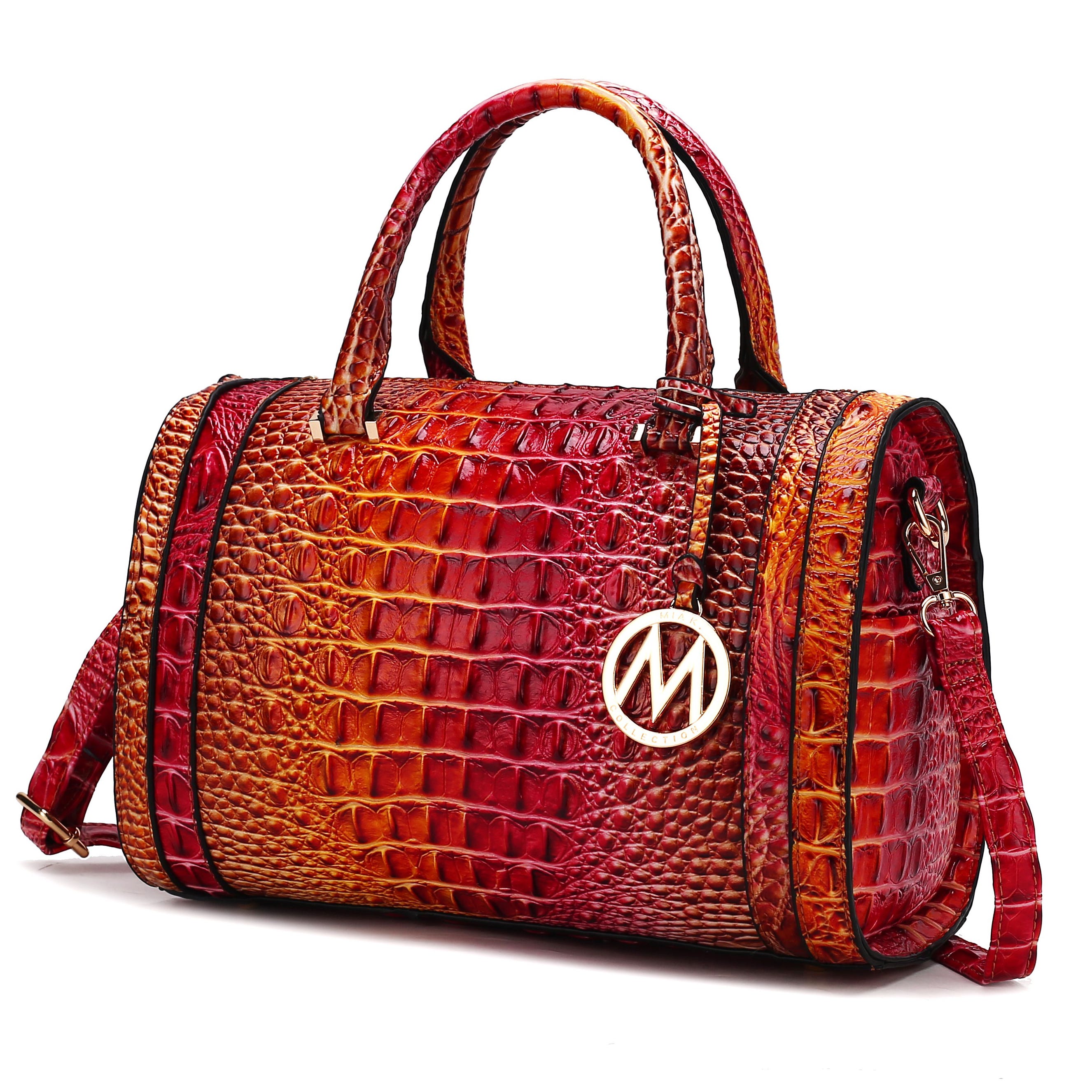 A textured red and orange crocodile-patterned handbag with gold accents and a prominent circular pendant featuring the letter \“M\“. It includes top handles and a detachable shoulder strap.