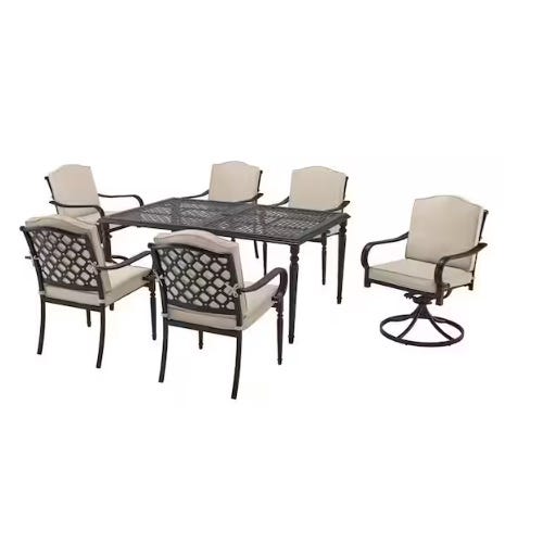 Outdoor dining set with a rectangular metal table and six cushioned chairs, one of which is a swivel chair.