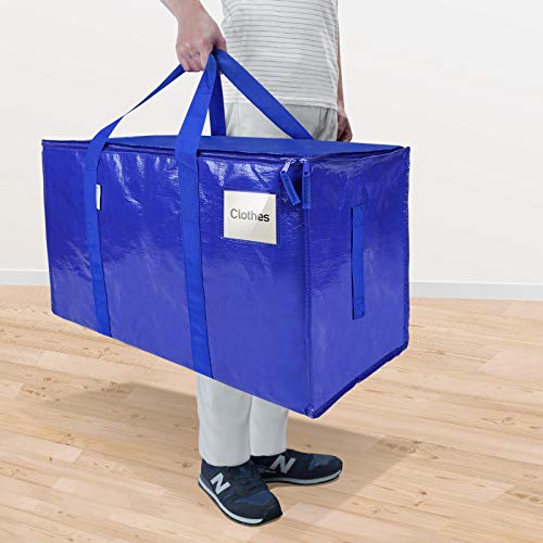 A person is holding a large blue moving bag with handles, labeled 'Clothes', suggesting the bag is intended for clothing storage.