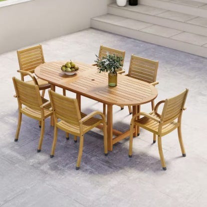 7-piece Amazonia Eucalyptus Patio Set with an oval wooden table and six matching chairs, featuring slatted designs. The table has a centerpiece with a vase and apples, suitable for outdoor use on a patio or deck.