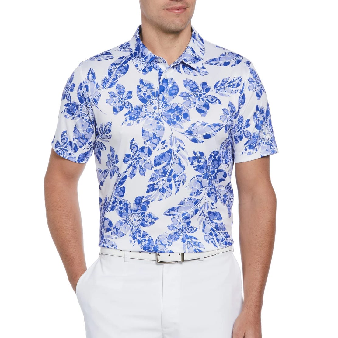 A man wearing a blue and white floral print short-sleeved shirt and white pants.