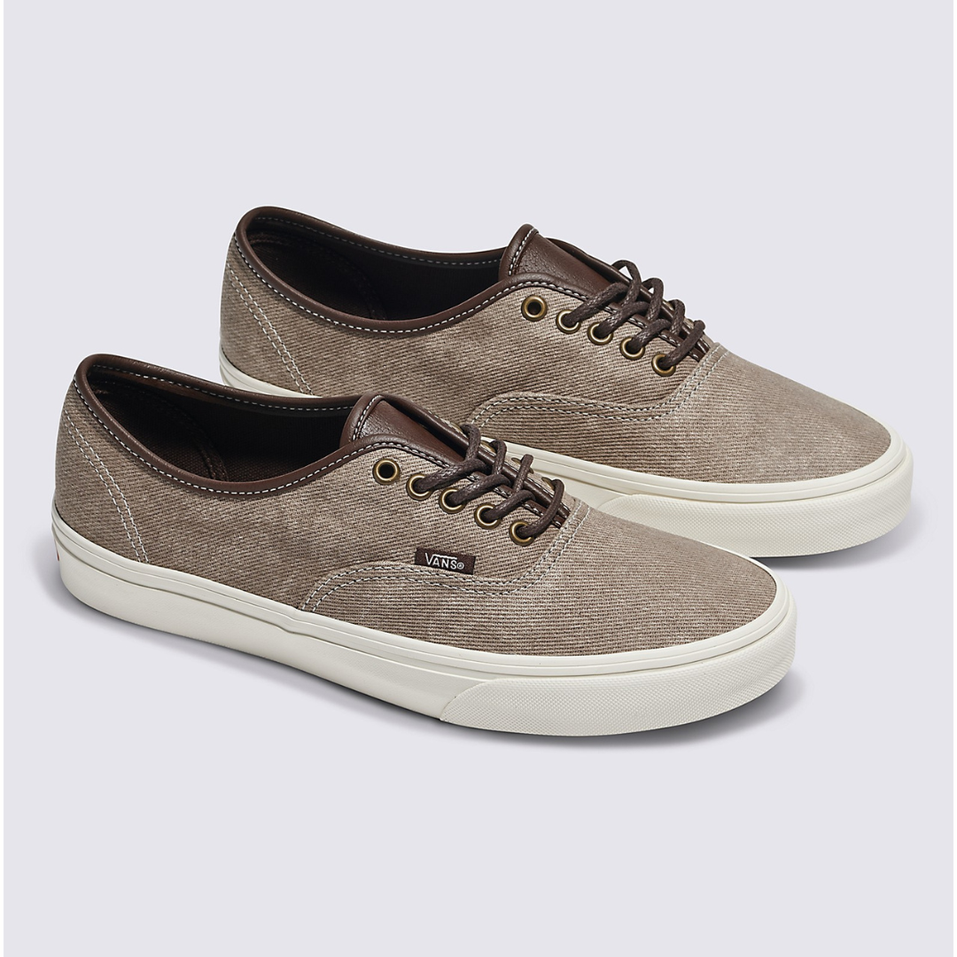 A pair of brown canvas sneakers with white soles and laces.