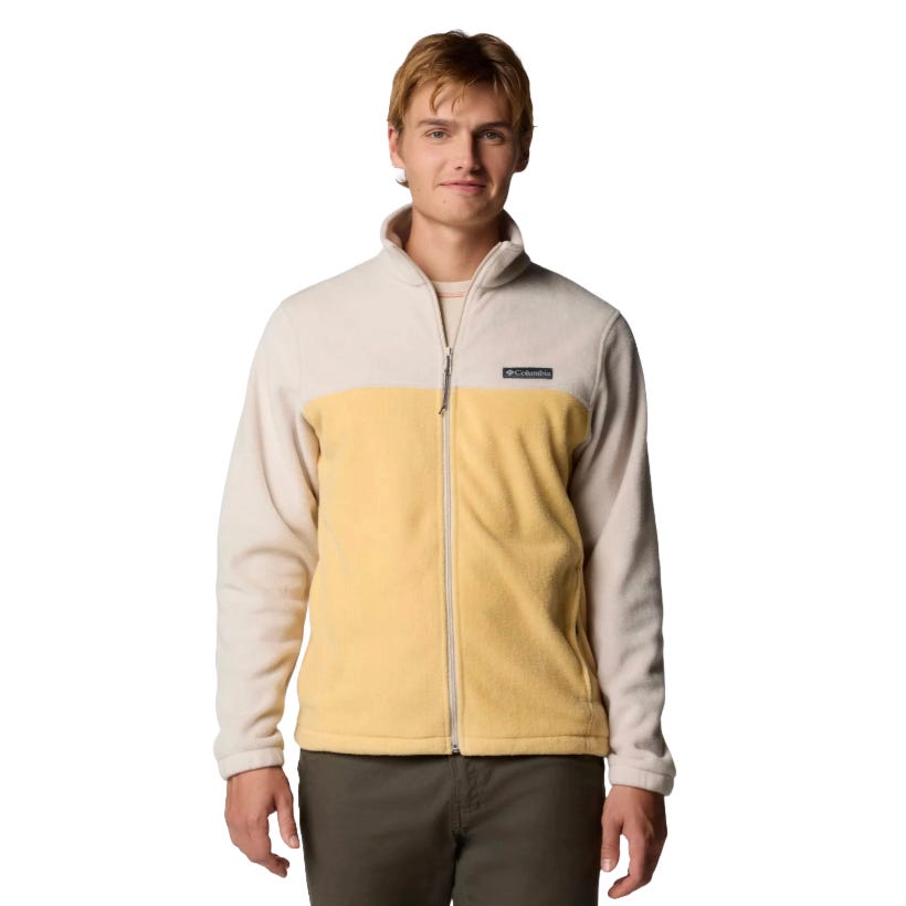 A man wearing a Columbia fleece jacket featuring a light beige and yellow design with a full-length zipper and brand logo on the chest.