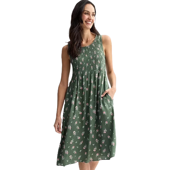 Sleeveless green dress with a floral print, featuring a gathered bodice and knee-length cut.