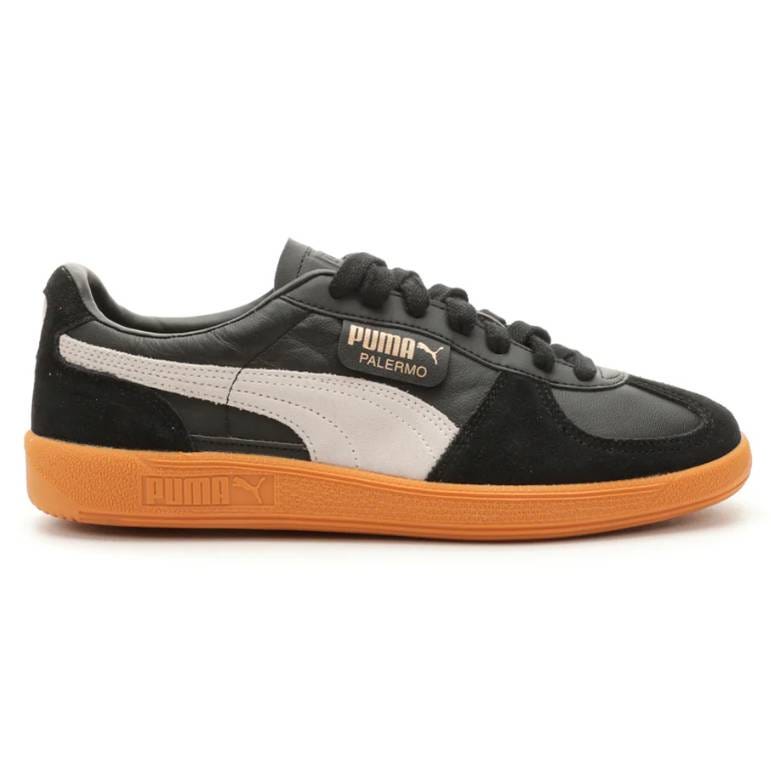 Puma Palermo sneaker in black with a white stripe and orange sole.
