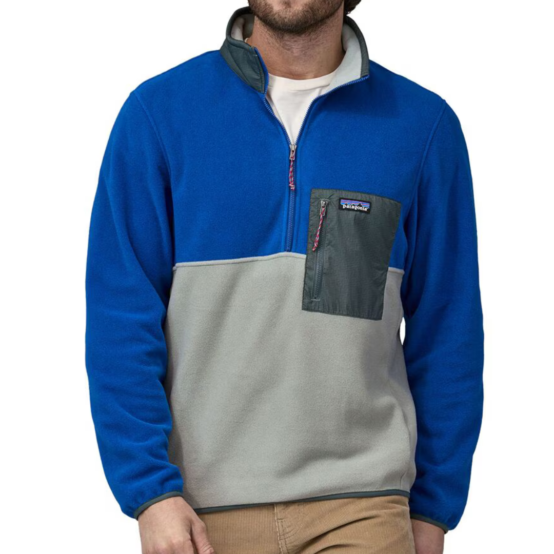A man wearing a blue and gray fleece pullover with a chest pocket.