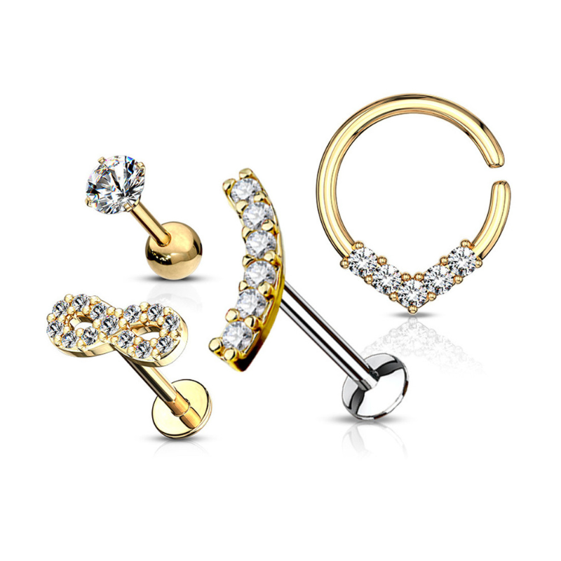 A set of four gold-toned earrings featuring two stud designs: a single crystal and an infinity symbol adorned with crystals, as well as two hoops, one with an arc of crystals and the other embellished with crystals at the bottom.