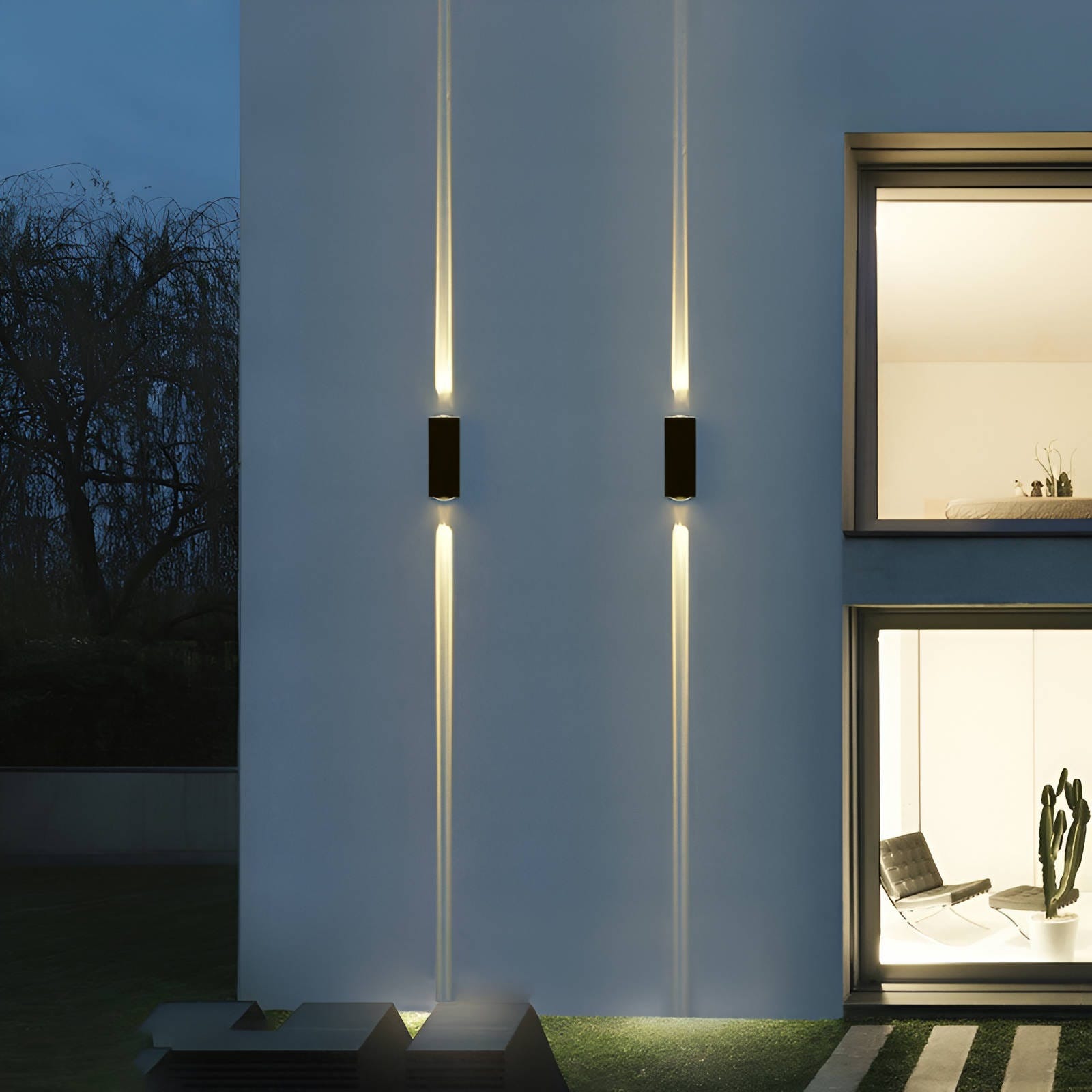 Two modern, vertical wall lights on a building facade, illuminating upwards and downwards.