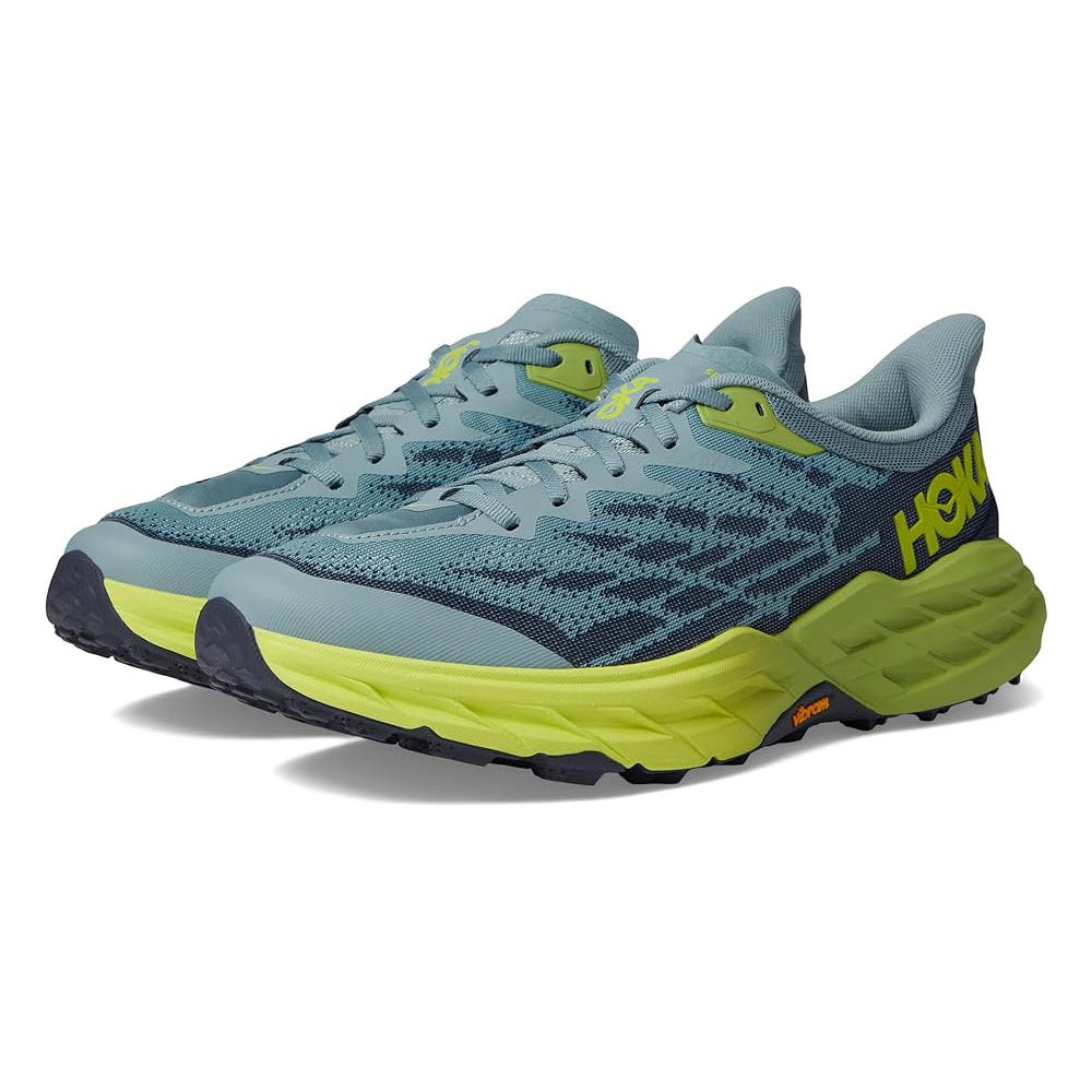 A pair of Hoka brand running shoes with blue and yellow accents.