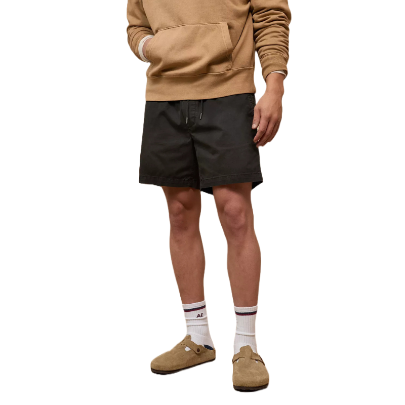 Black, knee-length trekker shorts with an adjustable waistband, paired with a tan hoodie, white socks, and brown slip-on shoes.