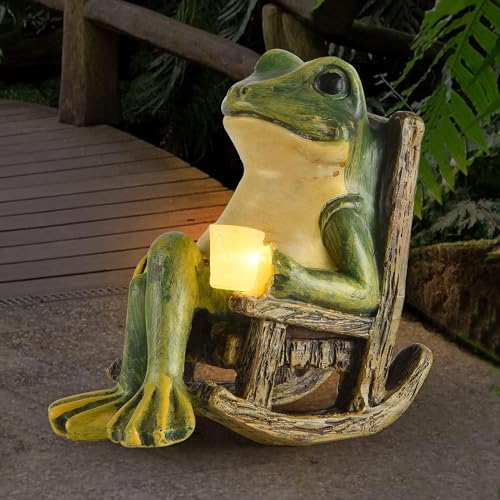 A statue of a green frog sitting on a rocking chair holding a yellow candle, designed for garden decor.