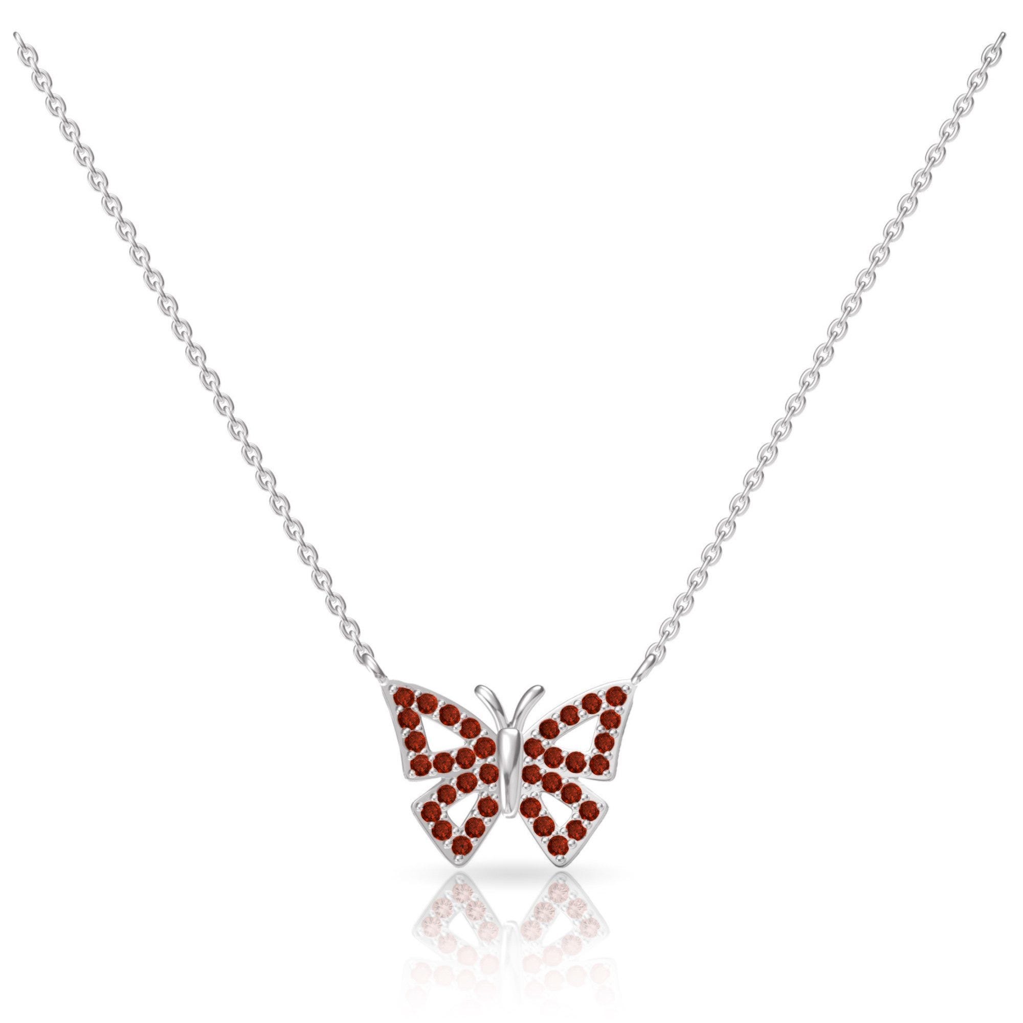 Silver chain necklace with a butterfly pendant adorned with red gemstones.