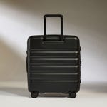 A black Antler luggage spinner with a ridged design, featuring four wheels and an extended handle.