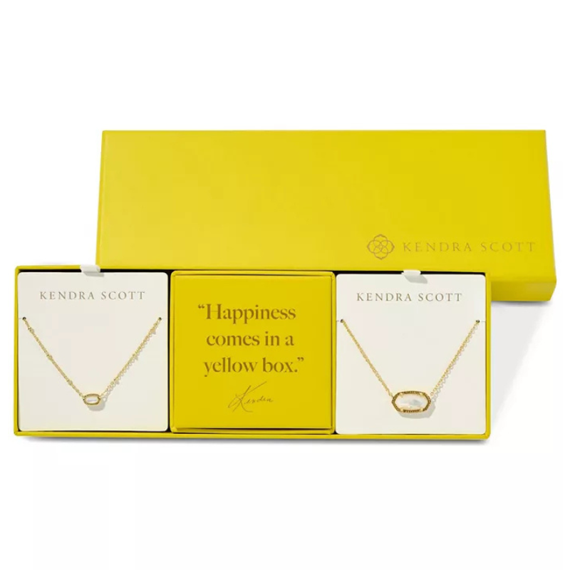 Kendra Scott jewelry set in a yellow box includes two necklaces. The box also features the phrase \“Happiness comes in a yellow box.\“