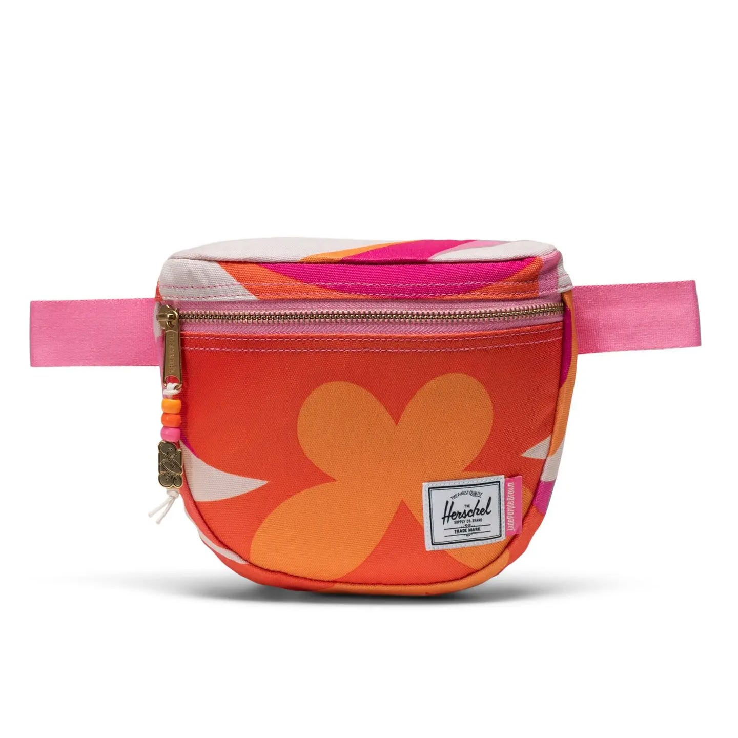 A colorful waist pack with a floral pattern and pink strap.
