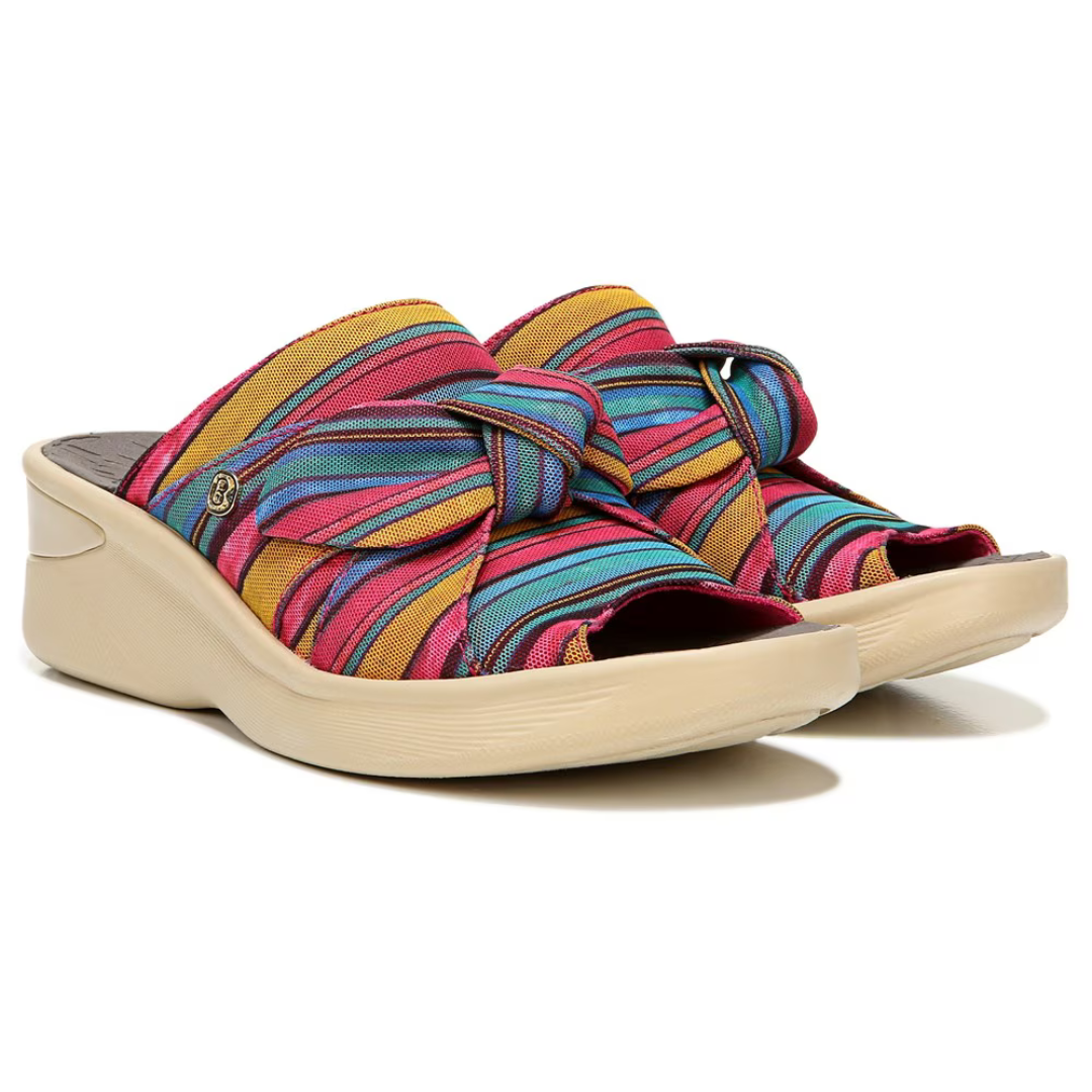 Brightly colored striped fabric crisscrosses over the tops of these wedge sandals, with an open toe design and a beige, platform-style sole.