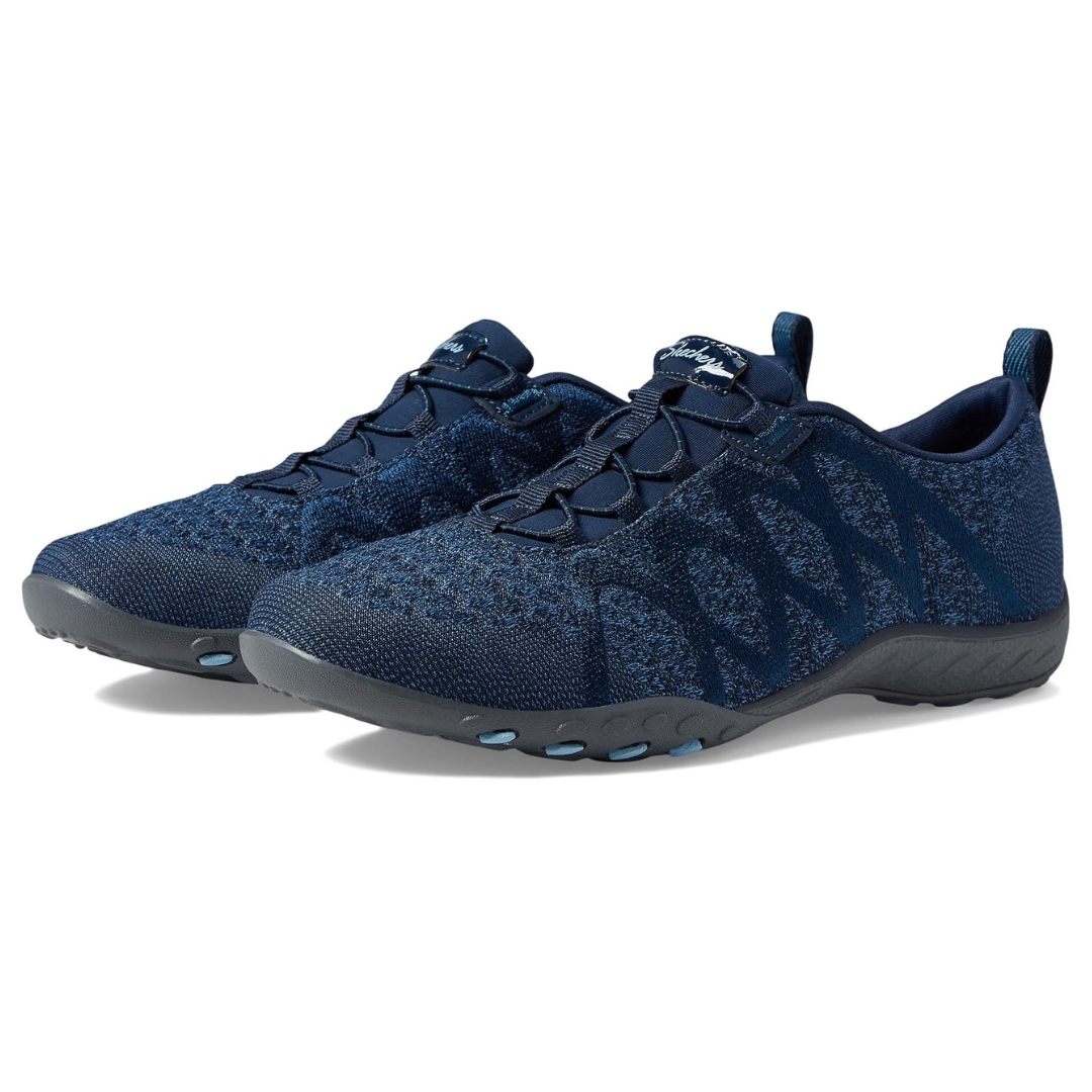Skechers Breathe Easy Sneakers feature a navy blue knit design with a slip-on style, elastic sides, and a flexible sole for comfort and easy wear.