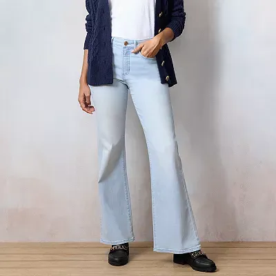 Light-wash, high-waisted jeans with a flared leg and a fitted waist, paired with a dark buttoned cardigan and black shoes.