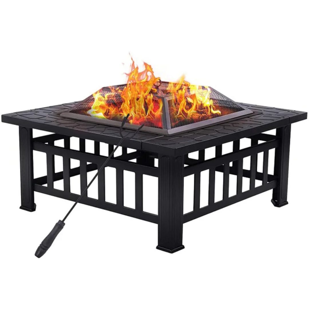 A square black fire pit with visible flames, accompanied by a poker tool.