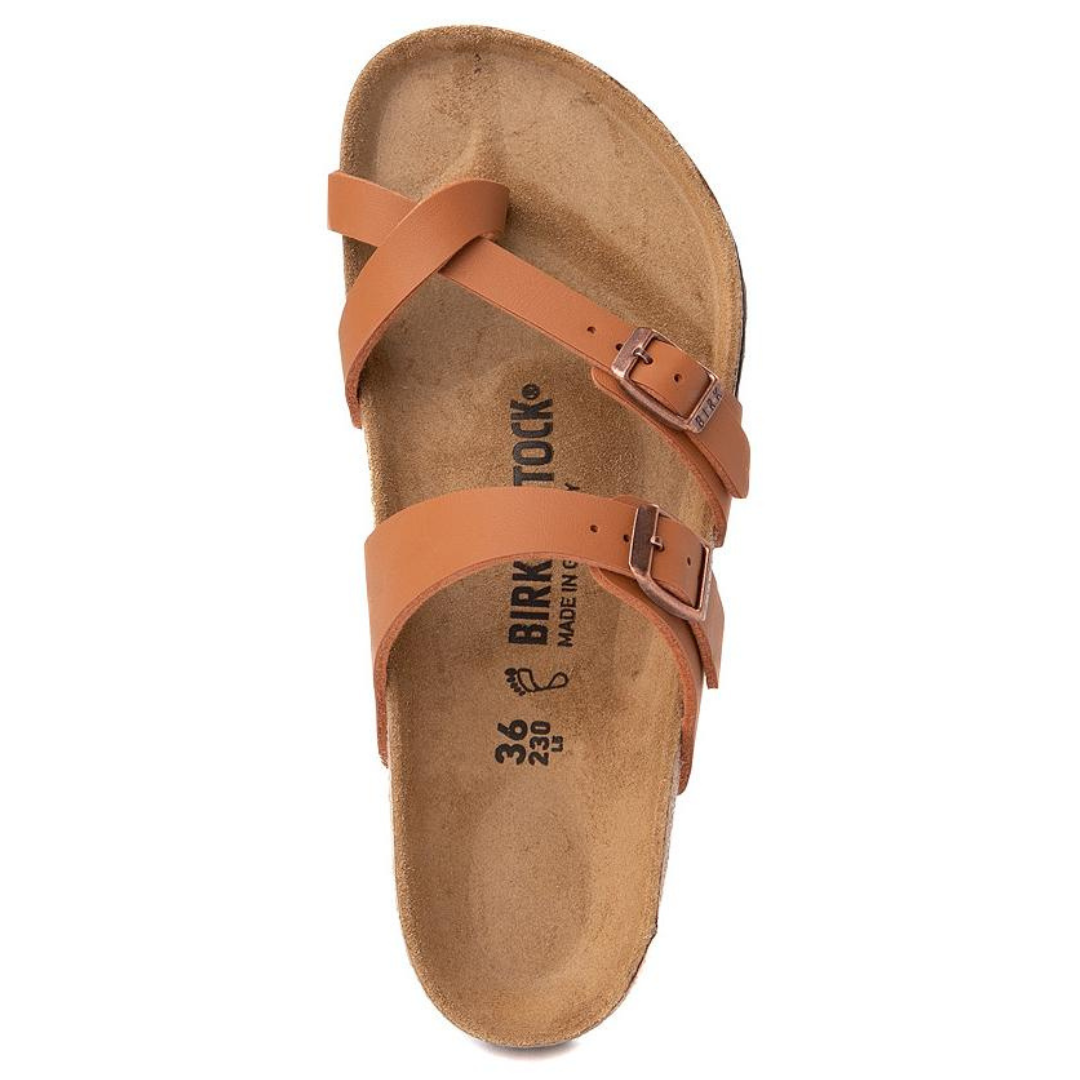 A single tan strap sandal with metal buckles and a contoured cork footbed.