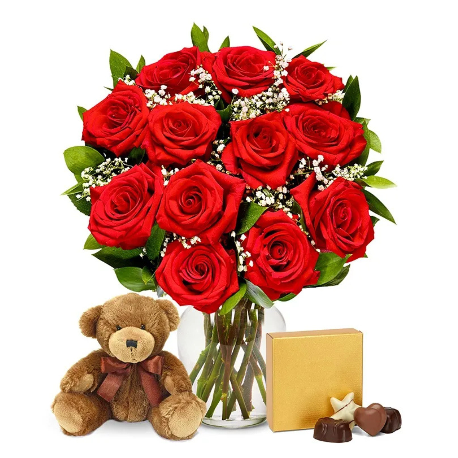 A bouquet of a dozen red roses with green leaves and baby's breath, accompanied by a small brown teddy bear with a bow and a box of assorted chocolates.