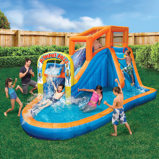 A colorful inflatable water slide with a pool and water-spraying arch, surrounded by children and a man playing.
