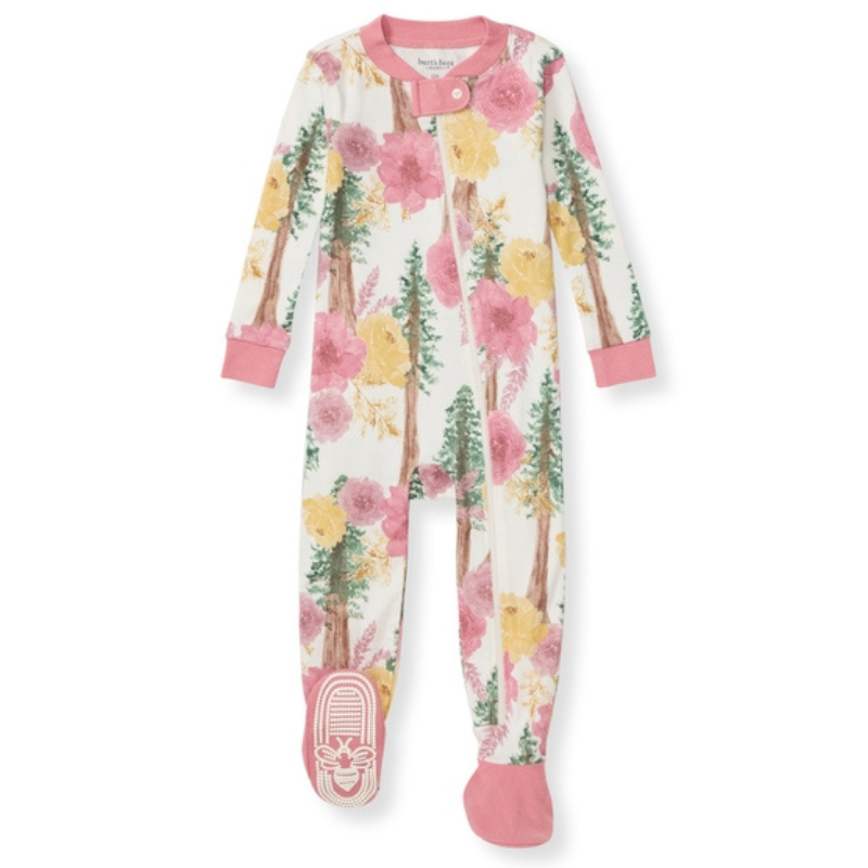 Redwood Floral Organic Cotton Pajamas feature a forest and floral pattern with pink and yellow flowers, green trees, and pink cuffs. They include a front zipper and non-slip bootie feet with an embroidered design on the soles.