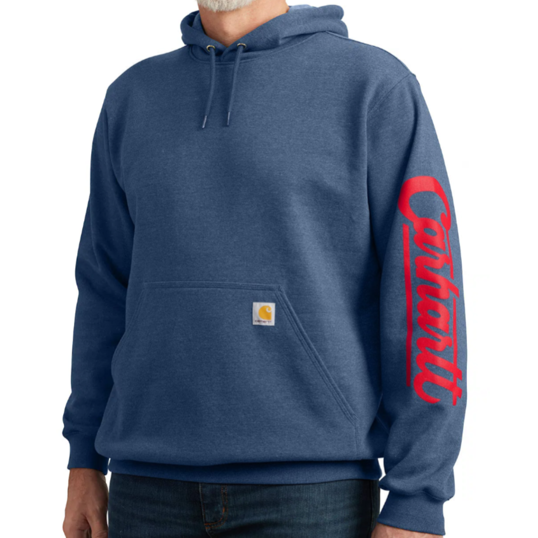 Blue hoodie with a front pocket and a hood, featuring \“Carhartt\“ written in red on the sleeve and a small brand logo tag on the pocket.