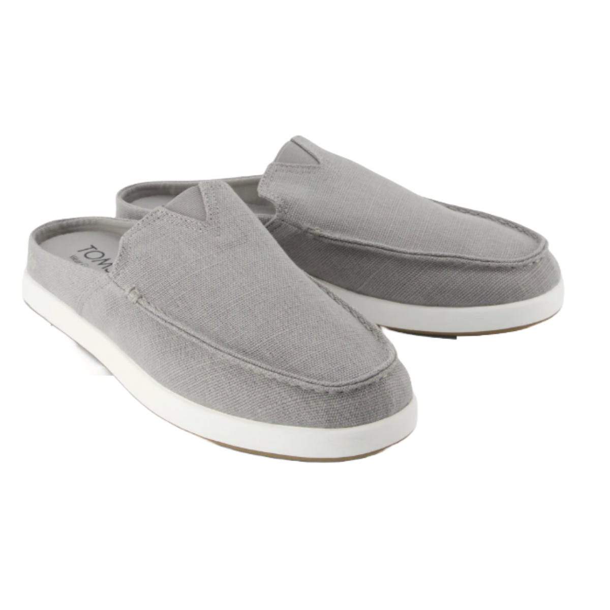 Men's TOMS Mules in light gray feature a slip-on design with a canvas upper, round toe, and white rubber sole.