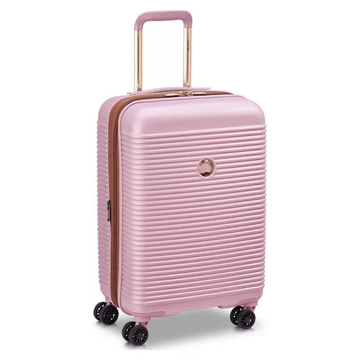 Pink hard-shell carry-on luggage with four spinner wheels and an extendable handle.