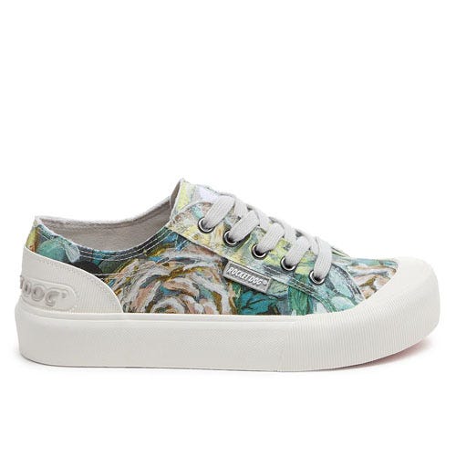 A low-top sneaker with a floral pattern, white rubber sole, and grey laces featuring a branded tag on the side.