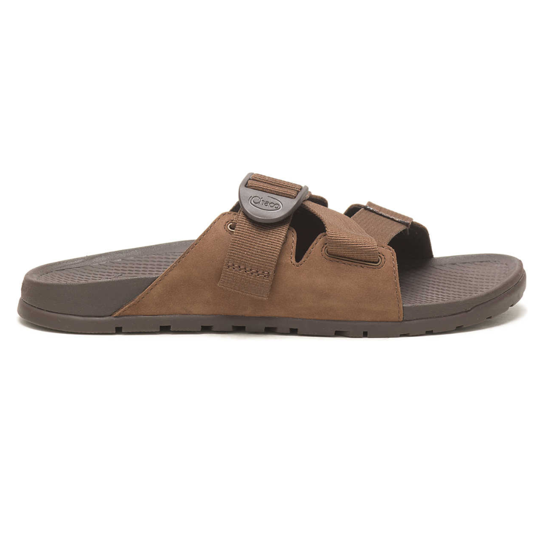 A single brown sandal with adjustable velcro straps and a label visible on the strap.