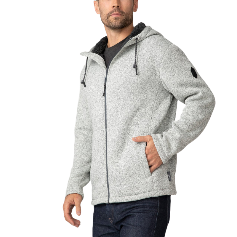 A gray, hooded fleece zip-up hoodie from Free Country features drawstrings and a soft, textured exterior. The garment has side pockets and a subtle logo patch on the sleeve.