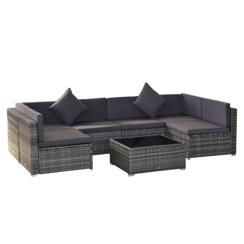 An L-shaped wicker patio sectional sofa with cushions and matching ottoman in dark tones.
