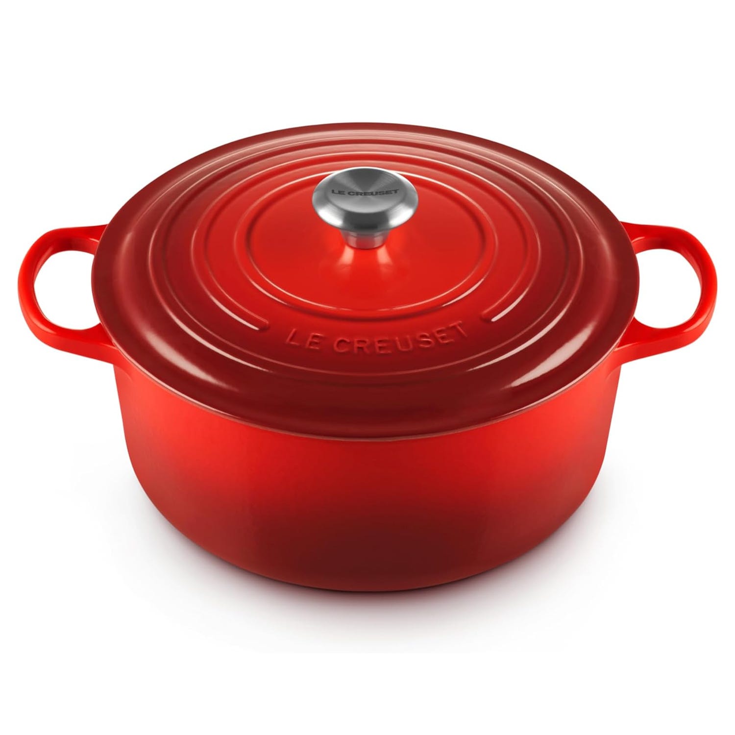 Red Le Creuset round Dutch oven with a stainless steel knob and two side handles, suitable for cooking and serving.