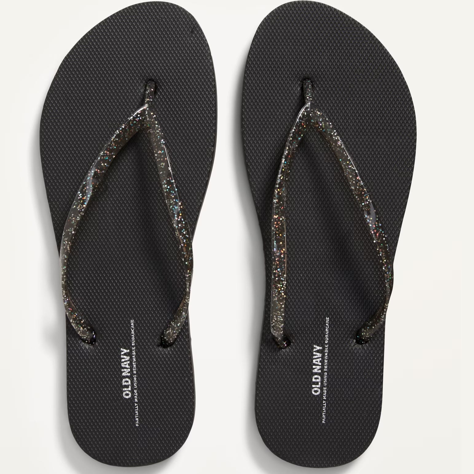 A pair of black flip-flops with glitter-embedded straps.