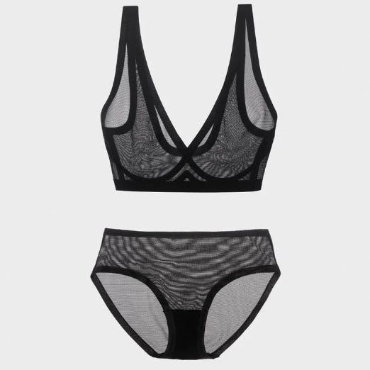 A black bralette with sheer lace detailing paired with matching sheer lace panties.