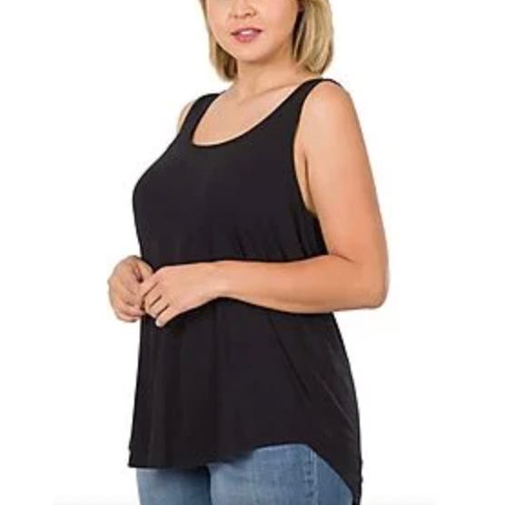 A woman is wearing a sleeveless black maternity top paired with blue jeans.