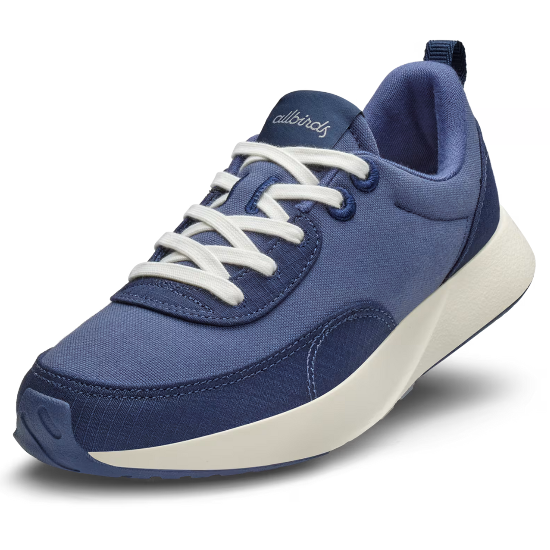 Allbirds Women's Courier Shoes are navy blue sneakers with a clean, minimalist design, featuring white laces and a cream sole.